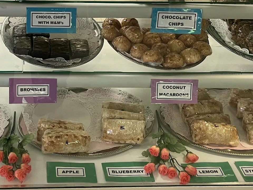 The pastry case at Glory’s: trays of cookies, brownies, coconut macaroons and turnovers, each with a printed name card